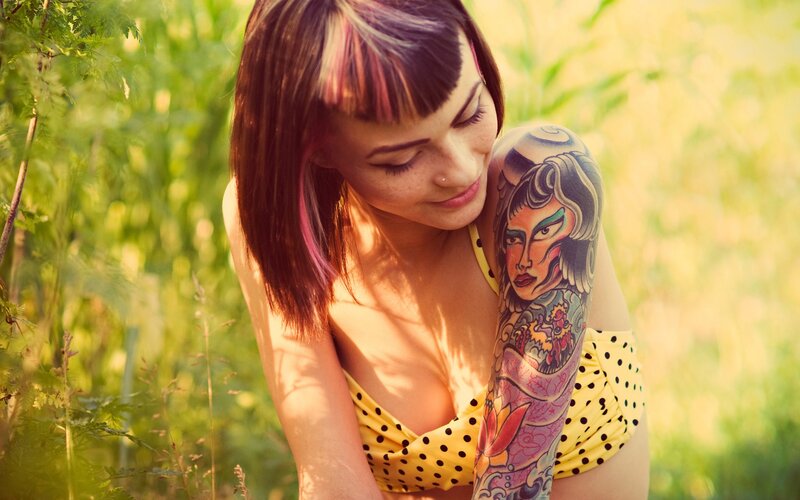 woman with tattoo in field