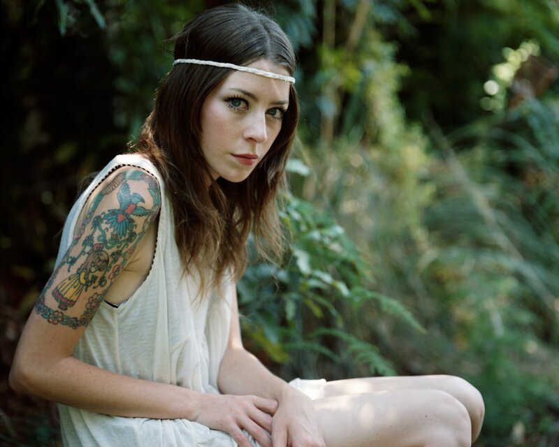 woman with tattoo in forest