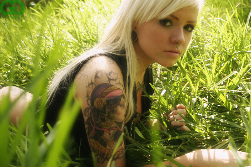 woman with tattoo in grass