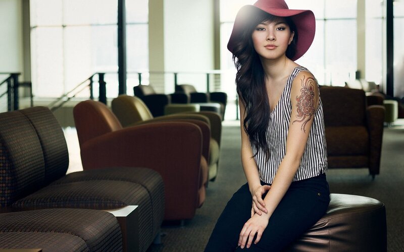 woman with tattoo in hat