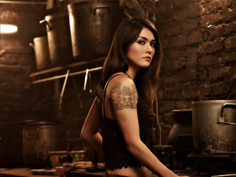 Woman with Tattoo in Kitchen — Brown