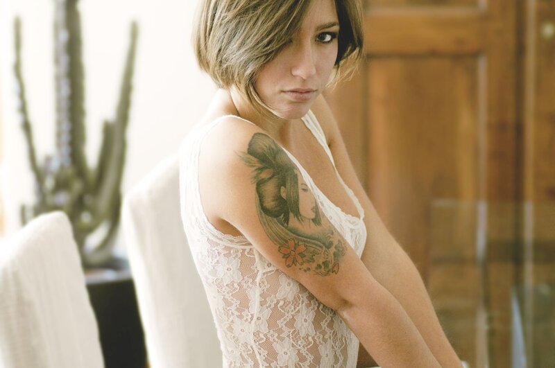 woman with tattoo in lace top