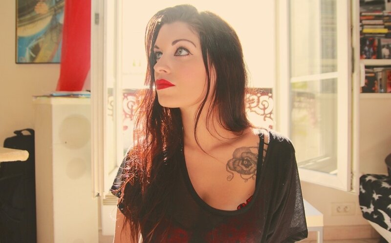 woman with tattoo in sunlit room