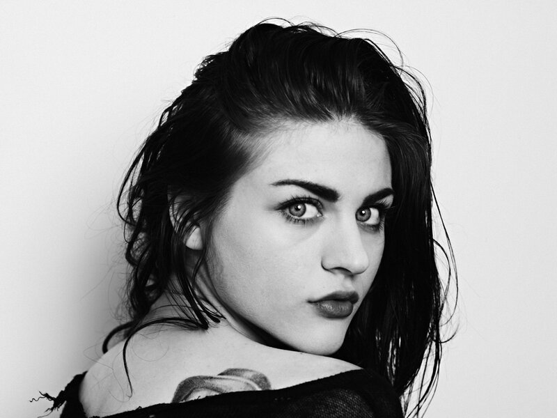 woman with tattoo looking at camera