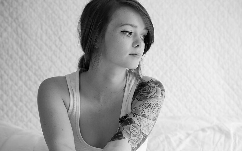 woman with tattoo looking away