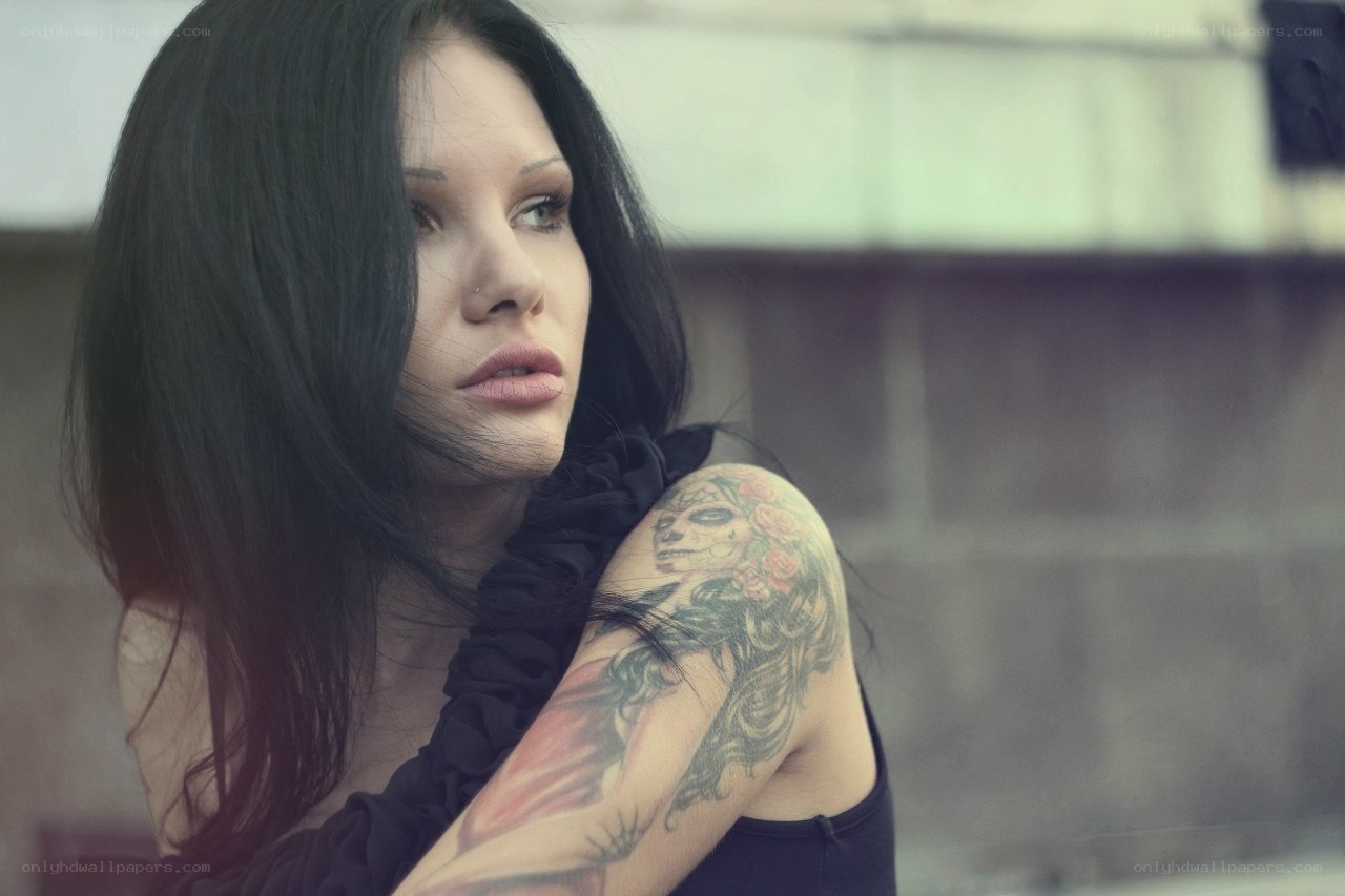 woman with tattoo looking away