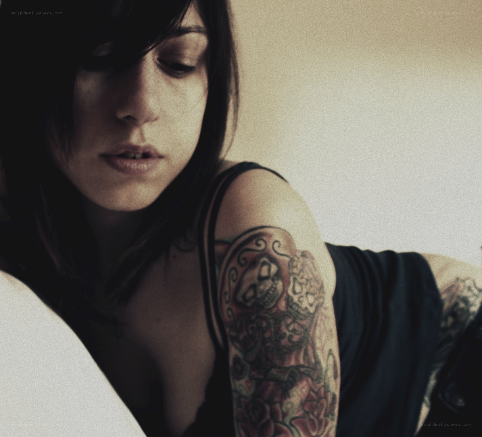 woman with tattoo looking down