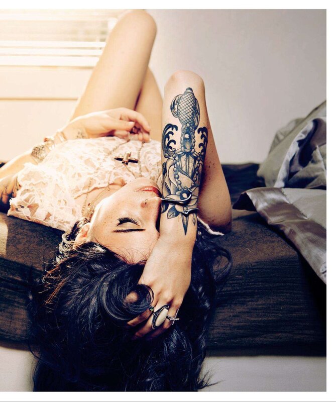 woman with tattoo lying on bed