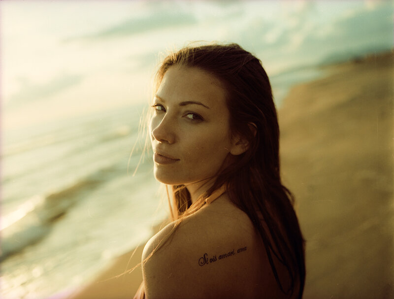 Woman with Tattoo on Beach — Gold