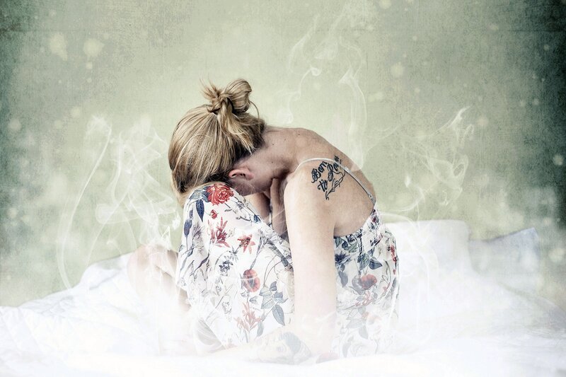 woman with tattoo on bed