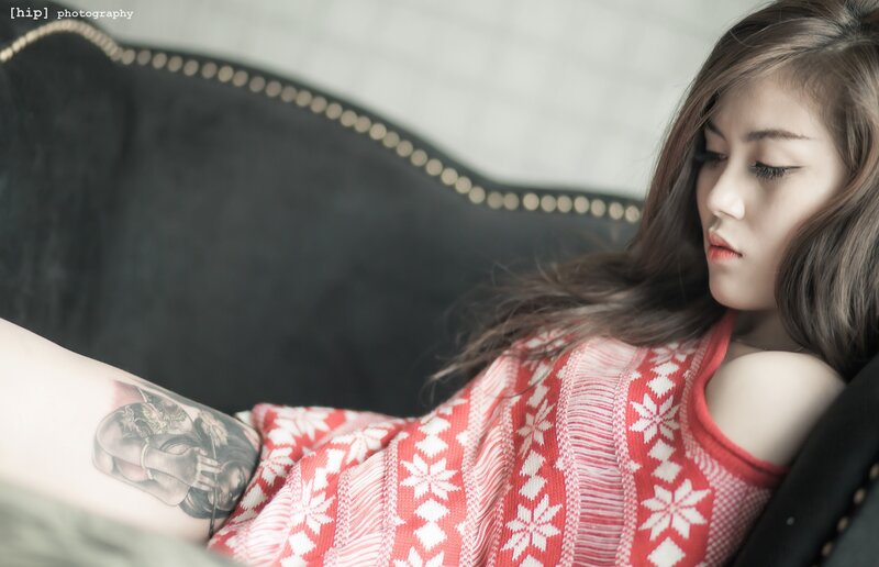 woman with tattoo on couch