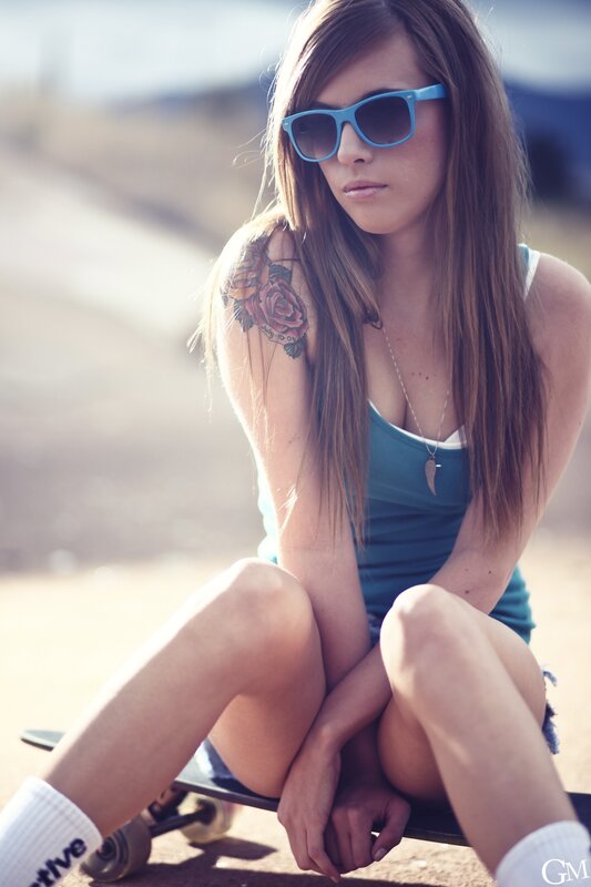 woman with tattoo on skateboard