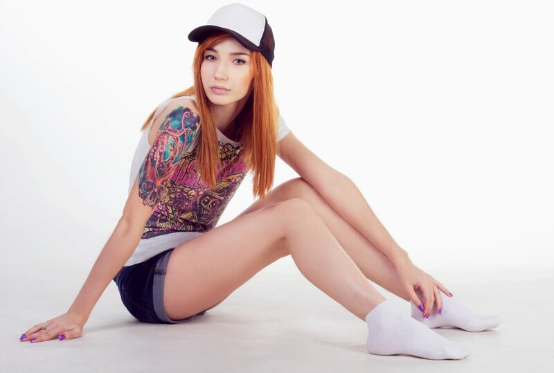 woman with tattoo sitting on floor