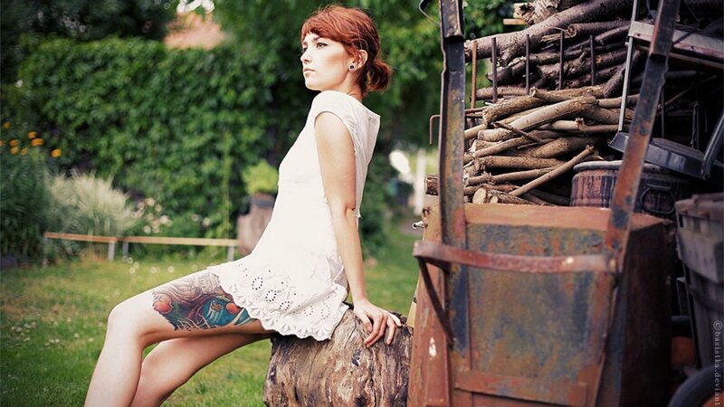 Woman with tattoo sitting outdoors