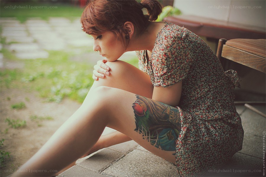 woman with tattoo sitting outside