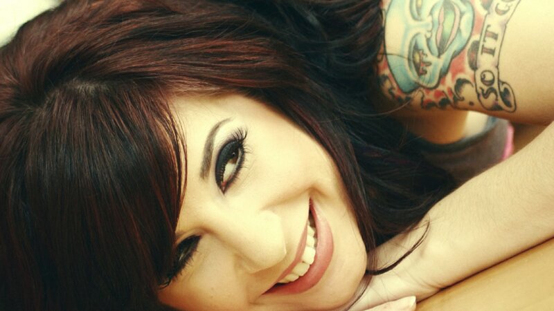 woman with tattoo smiling