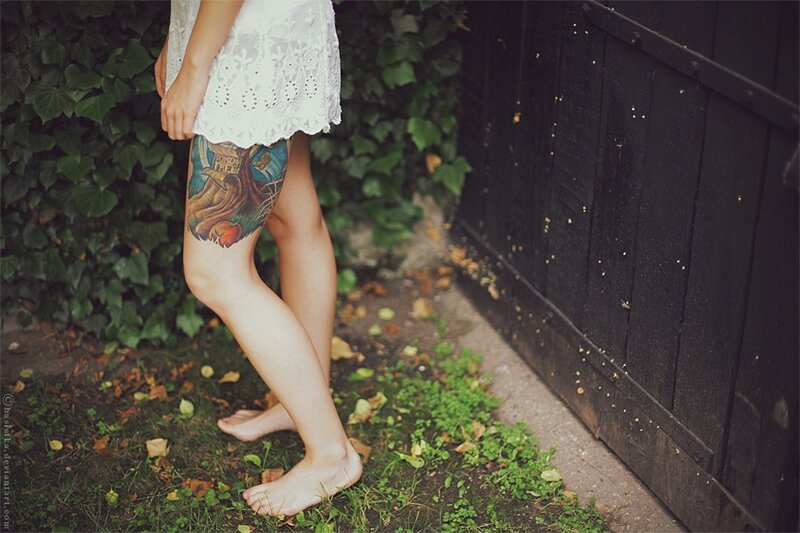 woman with tattoo standing barefoot