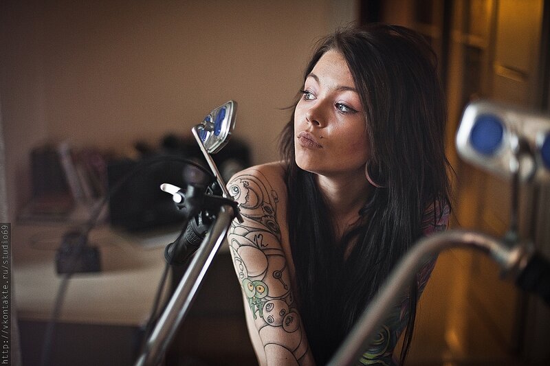 Woman with Tattooed Arm — Brown, Dramatic, Photograph