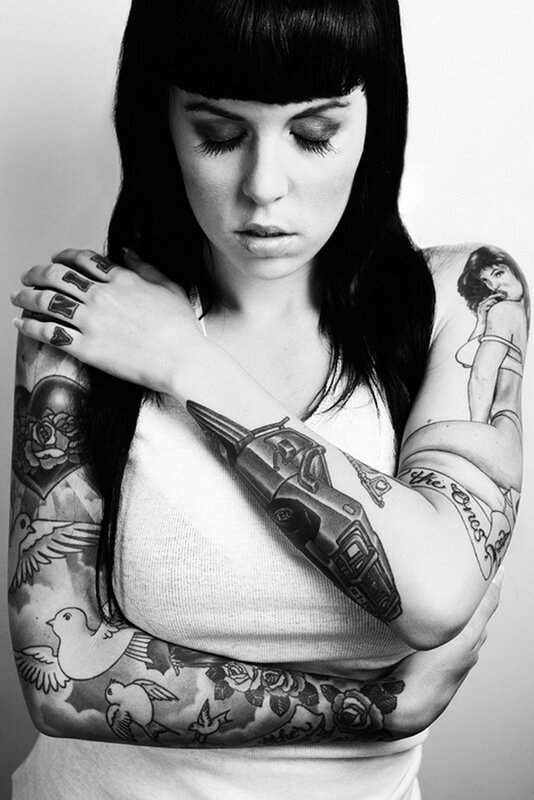woman with tattooed arms