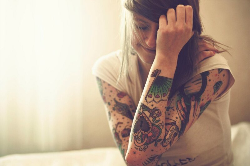 woman with tattooed arms
