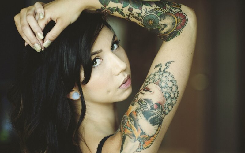 woman with tattooed arms