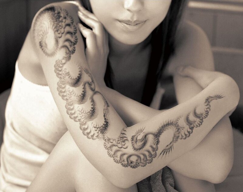 woman with tattooed arms