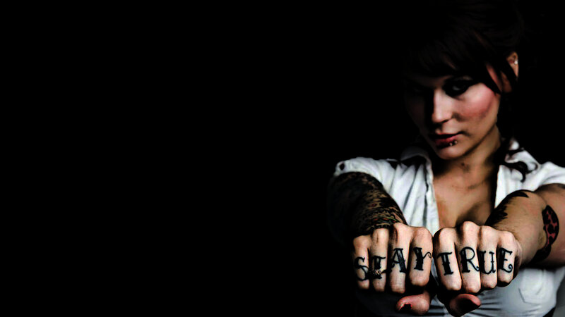 woman with tattooed fists