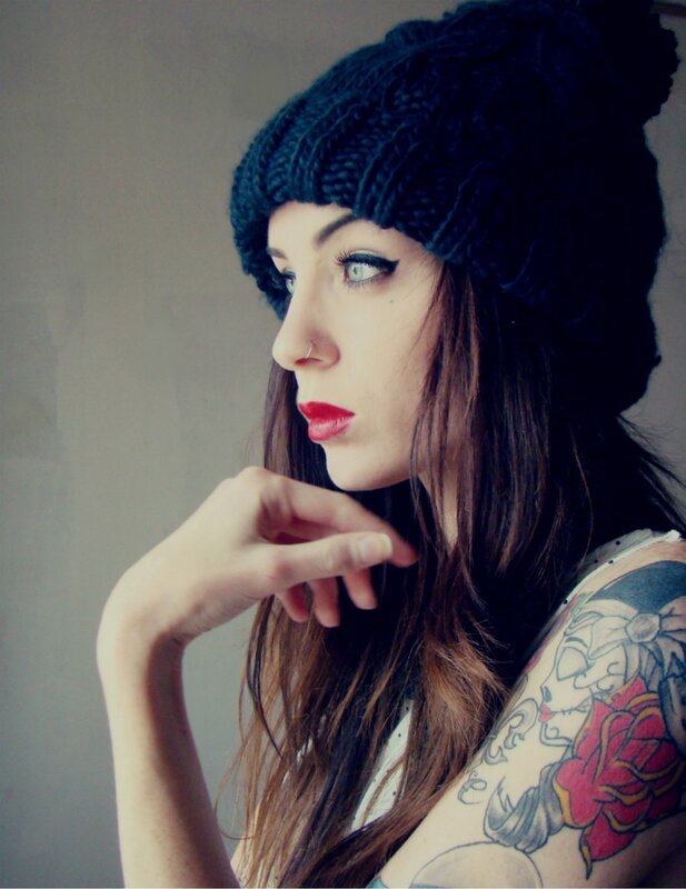 woman with tattoos and beanie