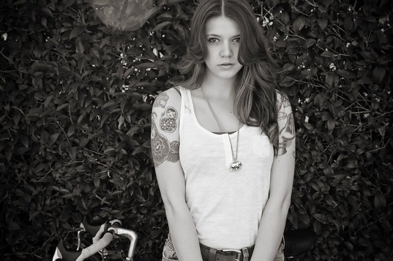 woman with tattoos and bicycle