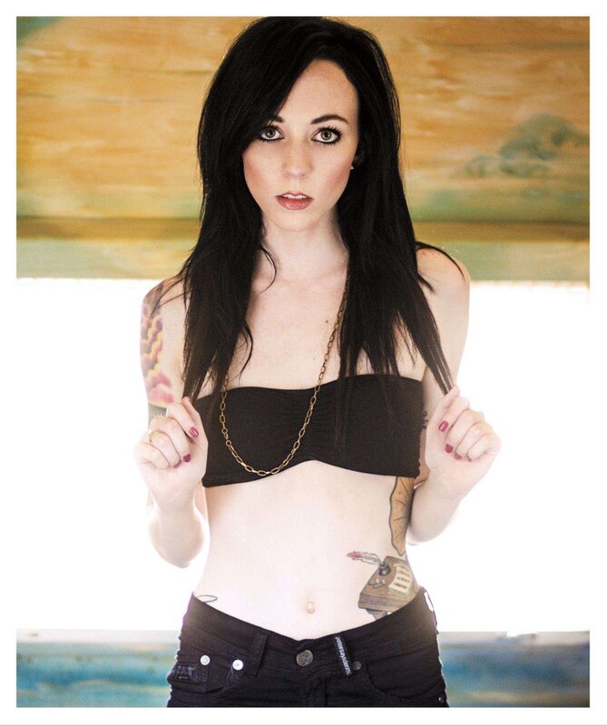 woman with tattoos and black top