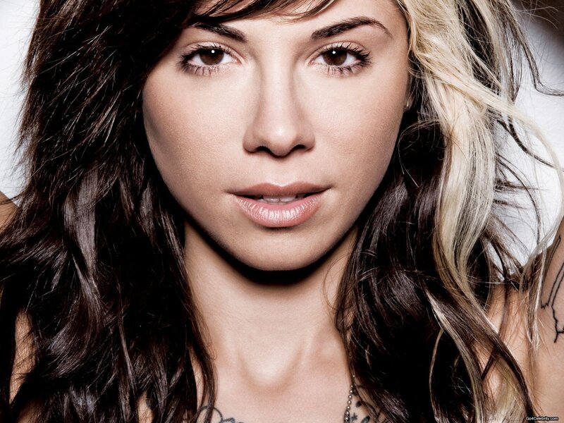 woman with tattoos and blonde highlights