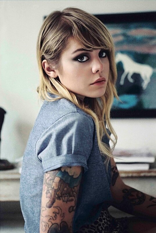 woman with tattoos and bold makeup