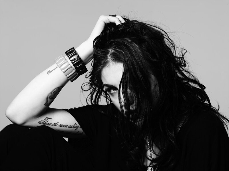 woman with tattoos and bracelets