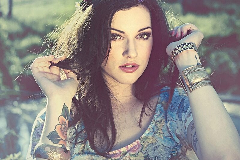 woman with tattoos and bracelets