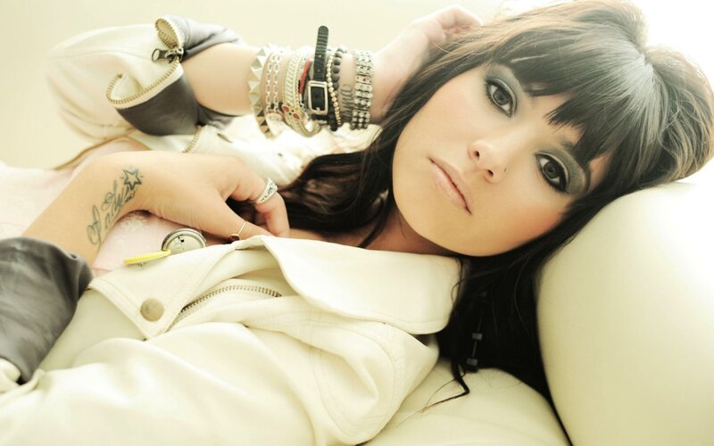 woman with tattoos and bracelets