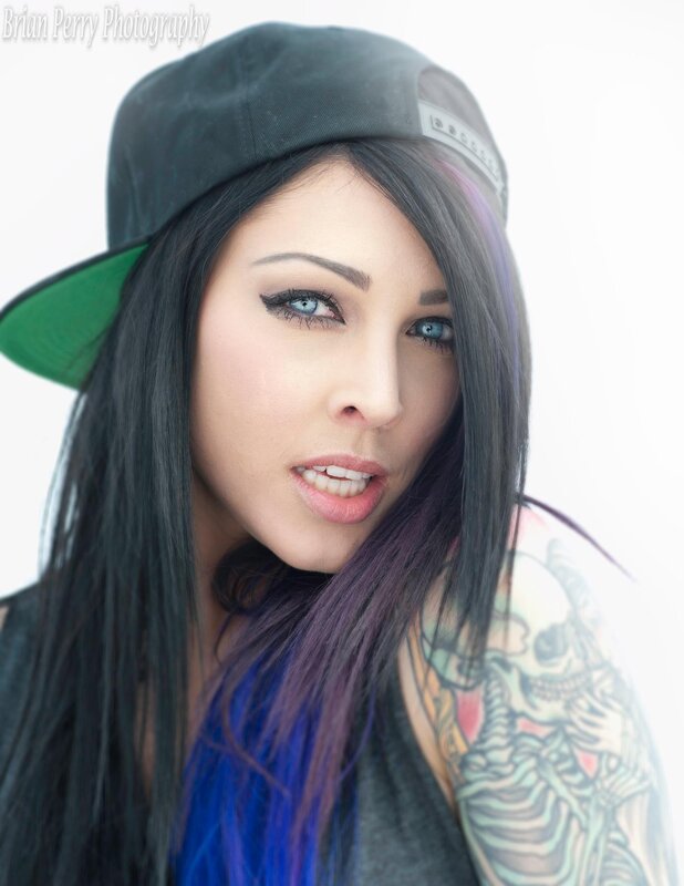 woman with tattoos and cap
