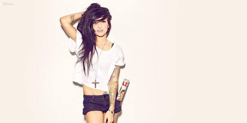 woman with tattoos and cross necklace