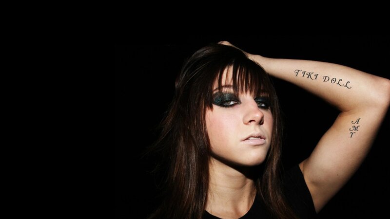 woman with tattoos and dark makeup