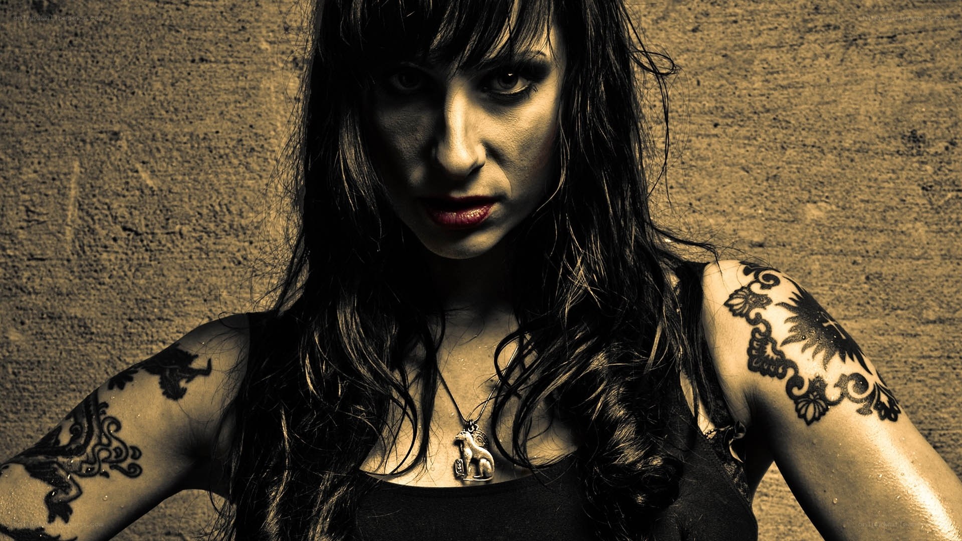 woman with tattoos and dark makeup