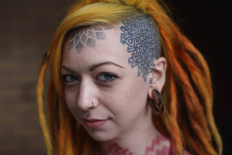 woman with tattoos and dreadlocks