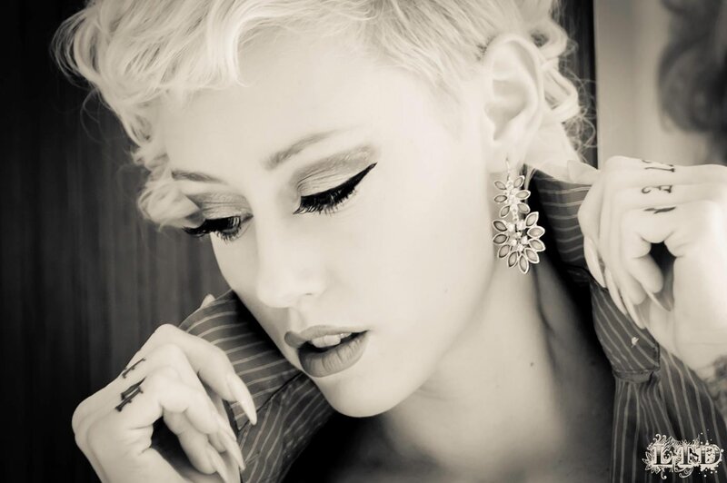 woman with tattoos and earrings