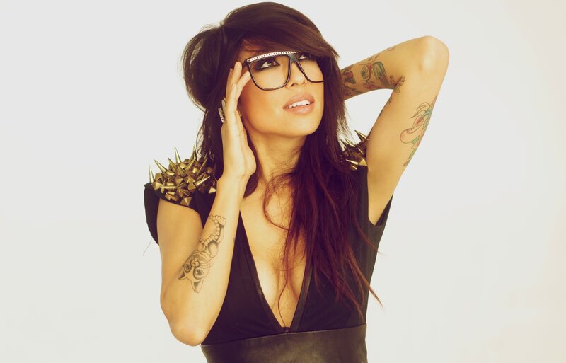 woman with tattoos and glasses