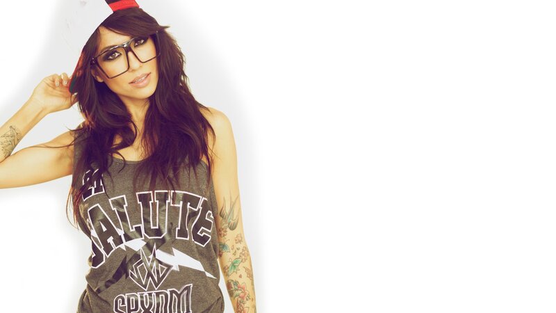 woman with tattoos and glasses