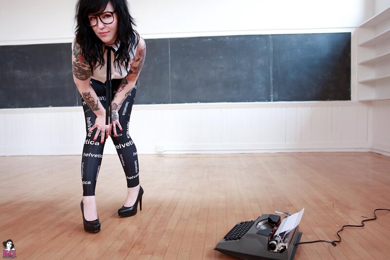 woman with tattoos and glasses