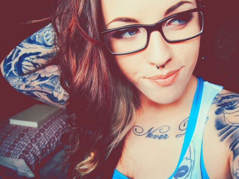 woman with tattoos and glasses