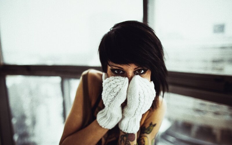 woman with tattoos and gloves