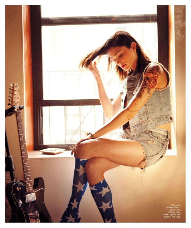 woman with tattoos and guitar