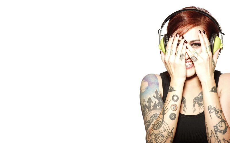 woman with tattoos and headphones