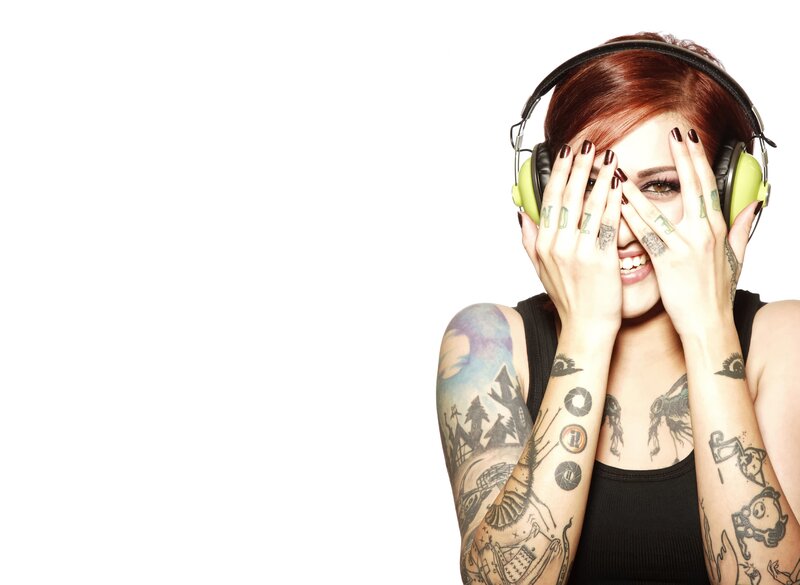 woman with tattoos and headphones