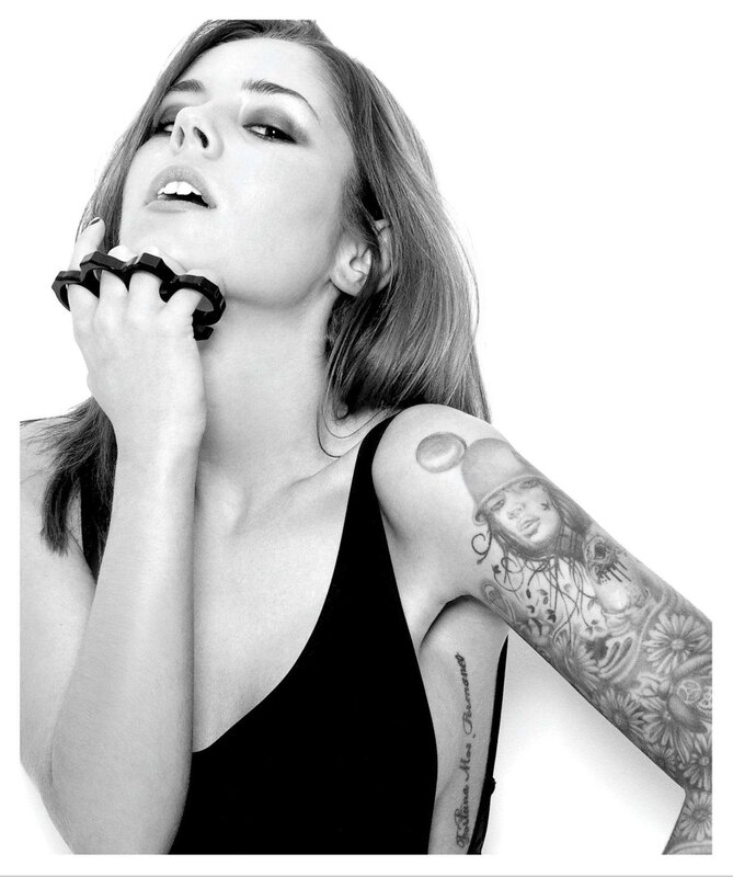 woman with tattoos and knuckle dusters